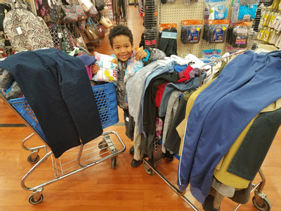 Tyler Stallings, age 6, shops for underclothes and other clothing items for female and male homeless veterans, in preparation for ... Tyler Stallings, age 6, shops for underclothes and other clothing items for female and male homeless veterans, in preparation for ...