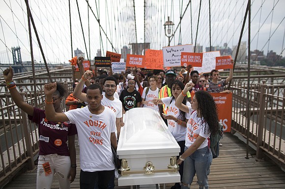 Thousands of demonstrators have marched across New York's Brooklyn Bridge in a protest against gun violence. Thousands of demonstrators have marched across New York's Brooklyn Bridge in a protest against gun violence.