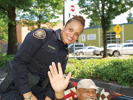 Police Chief Danielle Outlaw, the first African American female police chief in Portland history, was grand marshal of the Juneteeth parade. She is pictured atop a convertible with her father.