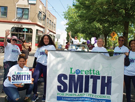 City Council candidate and current Multnomah County Commissioner Loretta Smith waves to onlookers and her supporters carry signs of solidarity at Saturday’s Juneteeth parade.