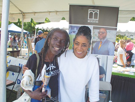 City Council candidate Jo Ann Hardesty greets Chonitia Smith at the Good in the Hood festival grounds.