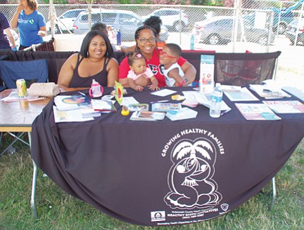 Malik Mathis (left) and Destiny Redmond of Multnomah County’s Healthy Birth Initiatives bring health information to the public at Good in the Hood.