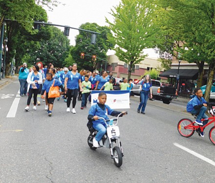 Young people march in the Good in the Hood Parade in conjunction with Legacy Emanuel Hospital.