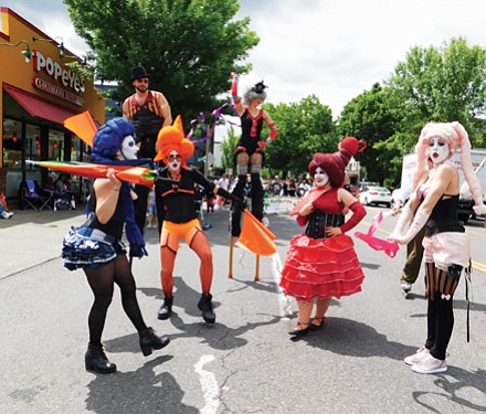 Performers from Rose City Circus awe onlookers with their outfits, athletics, and performance.