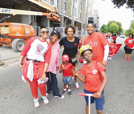 Parade-goers young and old enjoy the sunny day as the parade route stretches along Martin Luther King Boulevard.