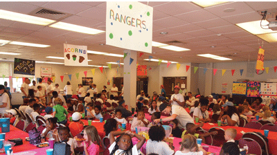 Eighty happy campers enjoying a pizza lunch.