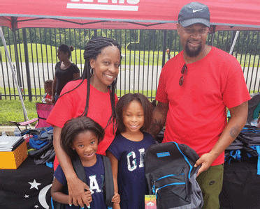 Once a year, Edward Moon— owner of the barbershop— and volunteers who comprise “Team Moon,” turn off their clippers and ... Once a year, Edward Moon— owner of the barbershop— and volunteers who comprise “Team Moon,” turn off their clippers and ...