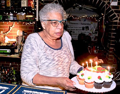 Veronica “Ronnie” Jackson, the owner of Roots Lounge for over 40 years and still going strong presents Birthday cake to “Rambling Rose."