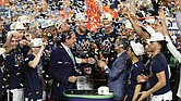 University of Virginia Cavaliers players celebrate their first NCAA Tournament championship win Monday night with Coach Tony Bennett, third from right, on the podium at U.S. Bank Stadium in Minneapolis. The team’s 85-77 victory over Texas Tech came during overtime. It was the first overtime victory in the tournament since 2008 and the eighth in tournament history.