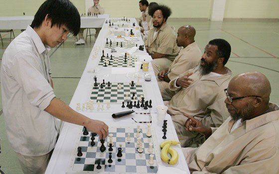 Princeton University student David Wang makes a move as he plays chess with inmate Kelvin Washington (right) at... Princeton University student David Wang makes a move as he plays chess with inmate Kelvin Washington (right) at...