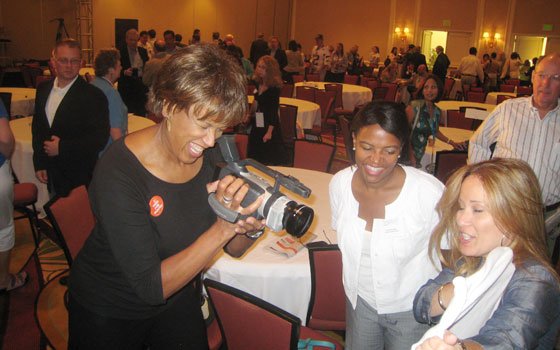 WBZ-TV broadcaster Liz Walker (left) interviews Giovanna Negretti of ¿Oíste? (right) with a handheld digital camera as state... WBZ-TV broadcaster Liz Walker (left) interviews Giovanna Negretti of ¿Oíste? (right) with a handheld digital camera as state...