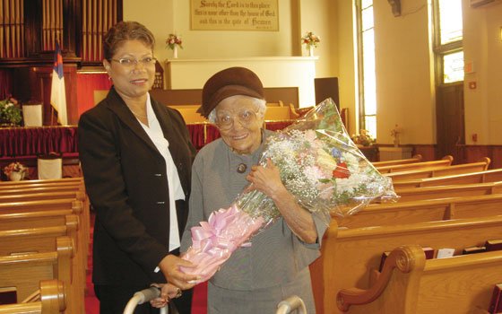 Gertrude Smith (right) holds a bouquet of flowers given to her by members of the Ebenezer... Gertrude Smith (right) holds a bouquet of flowers given to her by members of the Ebenezer...