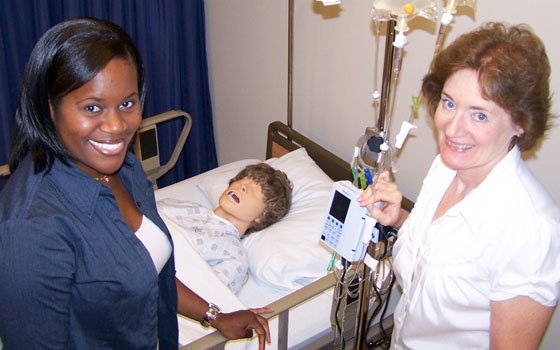 Nursing student Moriane Joseph (left) and associate professor Janice Meisenhelder flank a “patient” in the simulation lab at... Nursing student Moriane Joseph (left) and associate professor Janice Meisenhelder flank a “patient” in the simulation lab at...