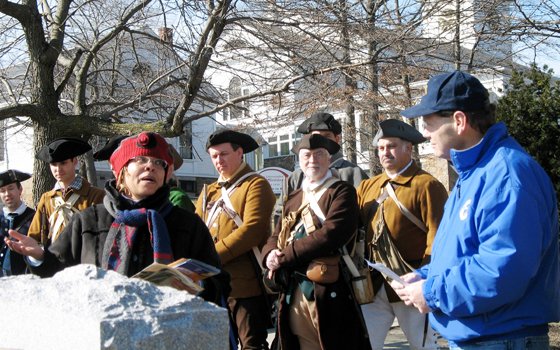 As Lexington Minute Men re-enactors look on, Dudley Square Main Streets Executive Director Joyce Stanley (left) and Michael... As Lexington Minute Men re-enactors look on, Dudley Square Main Streets Executive Director Joyce Stanley (left) and Michael...