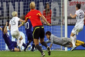 Japan and USA players fight to get the ball under the watchful eyes of German... Japan and USA players fight to get the ball under the watchful eyes of German...