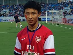 He runs alongside the Arsenal coach in Vietnam's capital Hanoi mile after mile. He bumps into trees and lamp posts ...