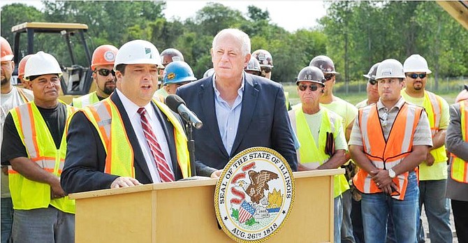  Ill. State Rep. Bob Rita (foreground) and Ill. Gov. Pat Quinn  speak at the work site for the connection construction between 1-294 and I-57. 
