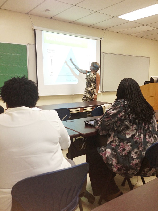 Dana Gaines (background) instructs a "Starting a Business In Illinois" workshop at Chicago State University (CSU). 