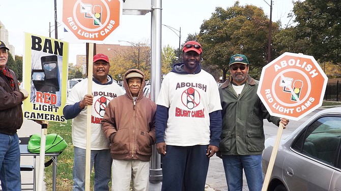 WVON Radio Talk Show host, Mark Wallace, pictured center, stands with members of a group he founded called the Citizens to Abolish Red-light Cameras during a red-light enforcement and speed camera protest at 53rd Street and Cottage Grove last month..