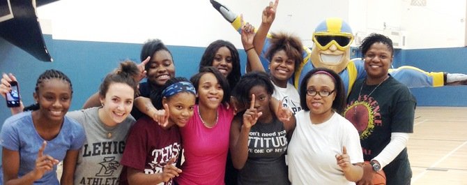 Hyde Park Academy girl’s basketball players and their coach pose with the Chicago Sky mascot, Fly Guy. The Chicago Sky, a professional women's basketball team based in Rosemont, Ill., donated much needed basketball apparel to the Hyde Park Academy Lady Thunderbird girls basketball team last month. 