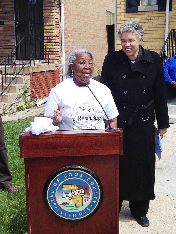 Mary Davis (front) speaks in front of her home, 1433 S. Lowe, at a press conference last weekend with Cook County Board President Toni Preckwinkle (back) as part of National Rebuilding Day and Rebuilding Together Metro Chicago's minor home repair project.