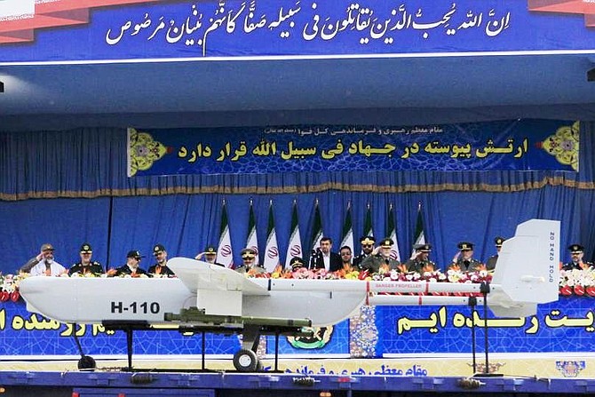Iranian President Mahmoud Ahmadinejad (C) looks at Iranian-made Sarir drone during Army Day parade at the mausoleum of the founder of the Islamic Republic, the late Ayatollah Ruhollah Khomeini in southern Tehran, Iran on April 18, 2013.