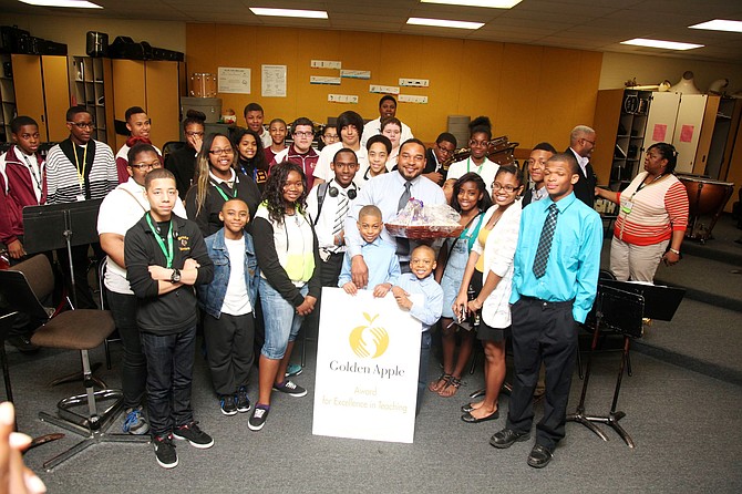 Roosevelt Griffin (Center) takes a picture with some of his students after learning he was named a 2014 Golden Apple Award recipient. 