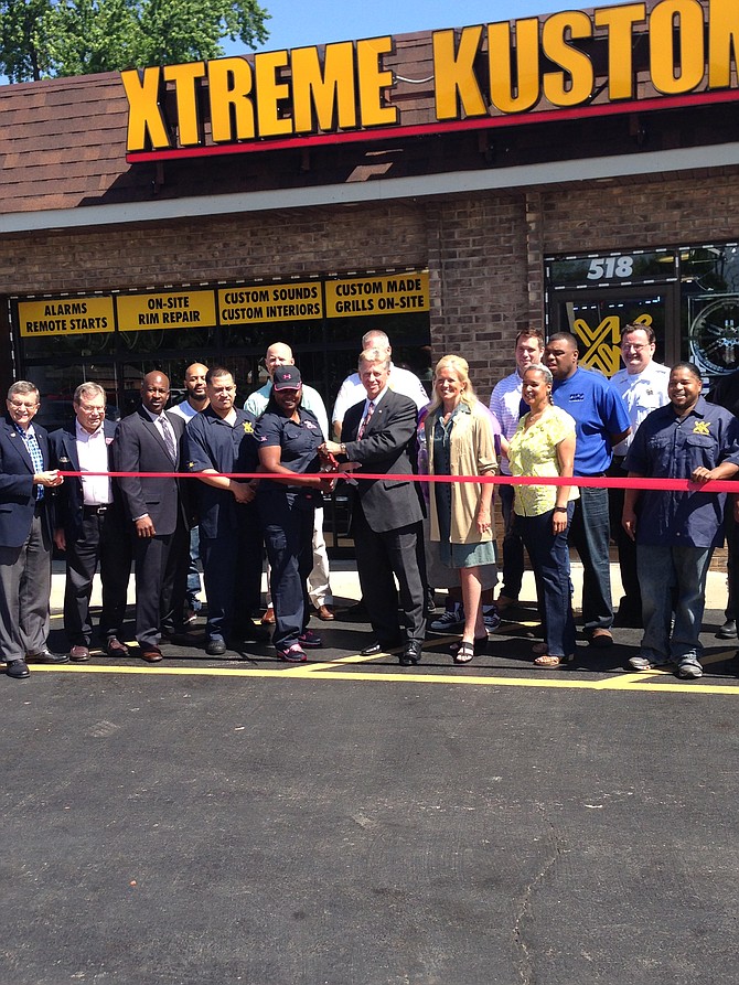 South Holland Village President Don A. De Graff (center) cut the ceremonial ribbon welcoming Xtreme Kustoms Wheels & Electronics, 518 E. 162nd St., South Holland, IL, to the community last week.