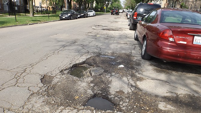 This pothole on Fulton Street between Francisco and Sacramento streets  is one of many that stretches along that block. To report potholes and request repair, Chicago residents are urged to call the City of Chicago's 311 or go to the City's website at cityofchicago.org.