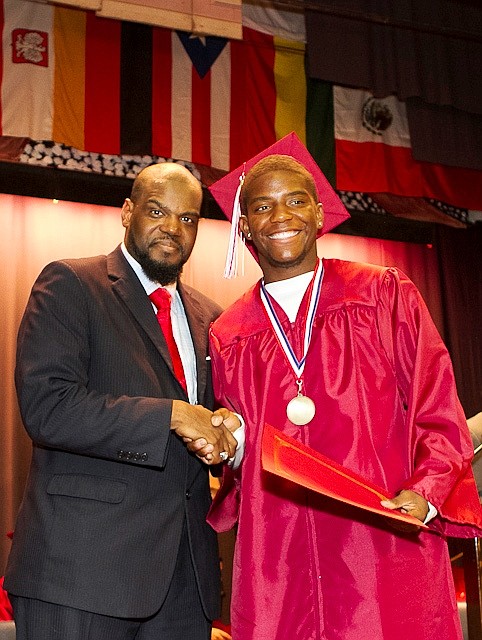 Ombudsman Chicago principal, Dr. Chaun Johnson, congratulates Nafis Maddox on graduating from Ombudsman Chicago.