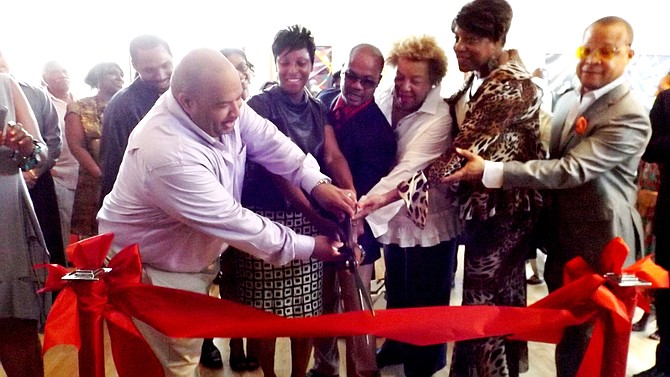 Artists Frances and Andre Guichard, pictured center, take part in the ribbon cutting ceremony of their newly opened, Gallery Guichard on 47th Street in Chicago, and are joined by Dr. Carol Adams, president and CEO of the DuSable Museum; Third Ward Ald. Pat Dowell and Ill. Sen.,. Ken Dukin (D-5th).