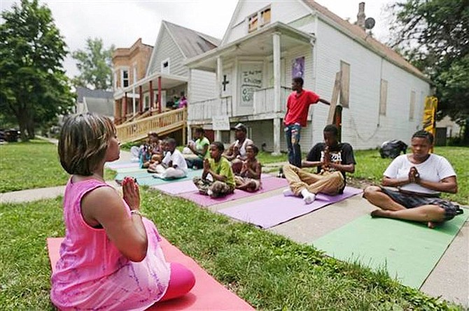 I Grow Chicago, yoga instructor, Tameka Lawson, leads a class outside the house at 64th and Honore in Chicago’s Englewood community.
