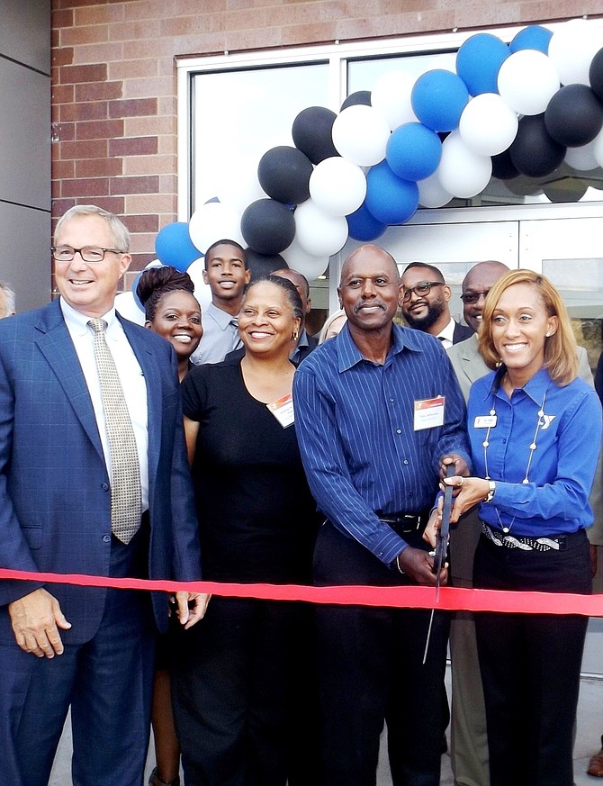 L-R Dick Malone, CEO, YMCA of Metro Chicago; Dr. Andrea Miller-Finch, DDS, member of the South Side YMCA Board of Directors; Tom S. Jefferson, Chairman of the South Side YMCA Board of Directors and Wendy Ellis, Ed.D., new executive director of the South Side YMCA on Sept. 4, 2014, taking  part in a ribbon cutting ceremony to reveal the two-year,  $3.6mm renovations to the South Side YMCA, located at 6330 S. Stony Island Ave.