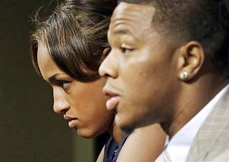 In this May 23, 2014, file photo, Janay Rice, left, looks on as her husband, Baltimore Ravens running back Ray Rice, speaks to the media during a news conference in Owings Mills, Md. A new video that appears to show Ray Rice striking then-fiance Janay Palmer in an elevator last February has been released on a website.
