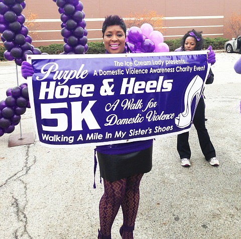 Latrice Mosley-Smith, founder of the Purple Hose & Heels 5K and owner of the Ice Cream Lady’s Haute Hosiery, proudly holds up the official 1st Annual Purple Hose & Heels 5K sign.  The event served the dual purpose of raising awareness about domestic violence and as a fundraiser for the South Suburban Family Shelter (SSFS), 18137 Harwood Ave., Homewood, Ill.