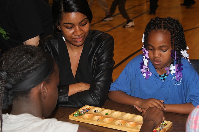 Off the Street Club volunteer challenges young members to a game of Mancala during the Club’s first 3rd Thursday event of the 2014-15 term at its west Garfield headquarters, 25 N. Karlov Ave. on Oct. 16. Off the Street Club, Chicago’s longest running boys and girls club, provides “casual joy” to local youth and has served as a community staple since 1900.