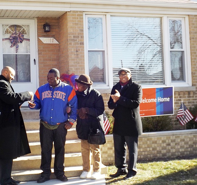 L-R: Willie McReynolds, Consumer Market Manager, Bank of America, Army Specialist, Renness Jones, Jones’ grandmother, Evelyn McGee and Chicago Ald. Howard Brookins, (21st Ward) shown Nov. 21, 2014, in front of Specialist, Jones’, new Roseland Community bungalow, courtesy of Bank of America and the Military Warriors Foundation.