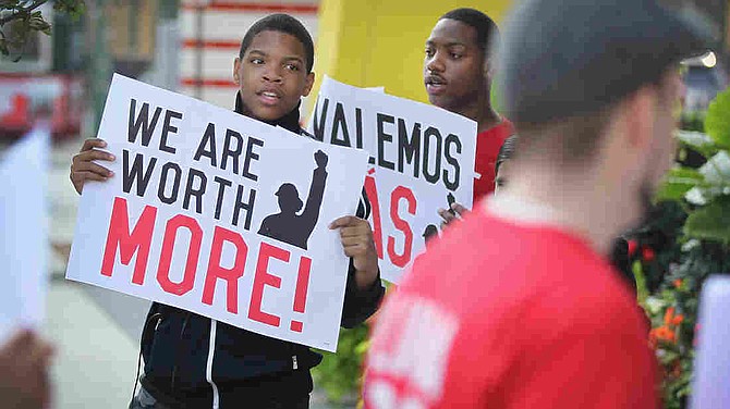 A new minimum wage was approved Tuesday in Chicago, where fast food workers and activists demonstrated outside McDonald's downtown restaurant this summer. 