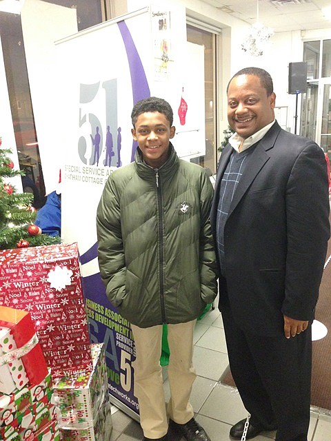 L-R: Roderick Sawyer, Jr. and Roderick Sawyer, Sr. are all smiles during the Chatham Business Association and Special Service Area (SSA) #51's Winterfest last week.  The Winterfest was held at 800 E. 78th St. as a “thank you” to customers who supported local Chatham businesses during CBA's Black Friday Plus initiative.