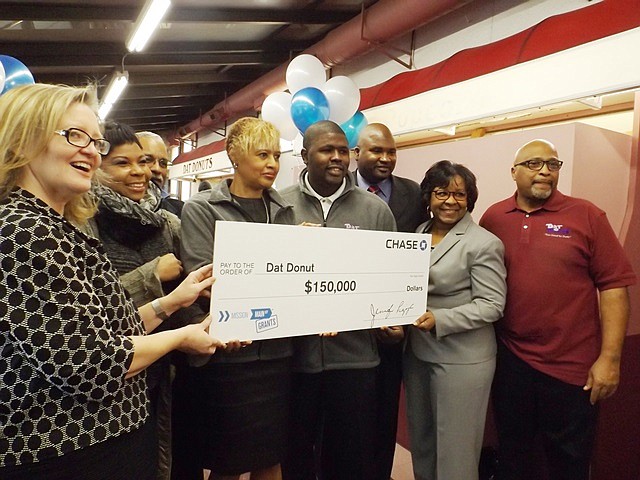 Laura Helmuth, Market Manager for Business Banking, Chase Bank Chicago; Melinda Kelly, Executive Dir. Chatham Business Association; Ill. Sen. Donne Trotter; Andrea Townson, owner of Dat Donuts; Michael McDonald, Gen. Manager, Dat Donuts, 82nd and Cottage Grove location; Ill. State Rep., Elgie Sims, Jr. (Dist.-34th); Chicago Ald. Michelle Harris, (8th Ward); and Darryl Townson, owner of Dat Donuts, pose for pictures Jan. 23, 2015, during the presentation of a $150,000 Chase Bank, Mission Main Street Grants program check.