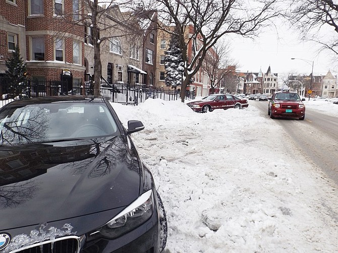 Cars still covered in snow on Tuesday, Feb. 3 along the 400 block of East Oakwood Blvd. following Sunday’s, Feb. 1, 2015  snow storm. Mounds of snow still need to be plowed and hauled away.