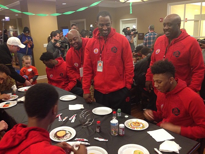  L-R  Simeon Career Academy coaches Fred Sculfield, Leonard Thomas and Robert Smith  share a laugh with McDonald's All American players as they decorate cookies at The Ronald McDonald House® of Chicagoland & Northwest Indiana, 211 E. Grand Ave.  Under the leadership of head coach, Robert Smith, Simeon Career Academy has won six Illinois High School Association champions.