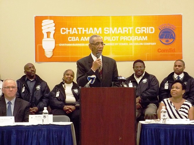 Michael McMahon, vice president of smart grid technology for ComEd, U.S. Cong. Bobby Rush (Dist.-1) and Melinda Kelly, Exec. Dir., Chatham Business Association. Back row seated, Dwain Geoghegan, Madeline Morgan, George Sims, Clifford Borner, II, participants in Chatham Business Association/ComEd, pilot, smart grid outreach, pilot training/employment program.