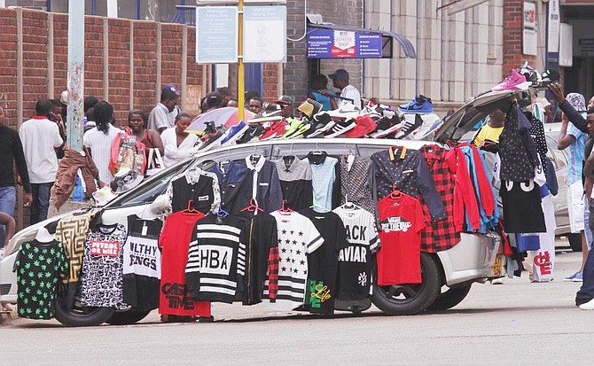 Vendors display their wares on their vehicles.