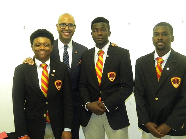 L-R Urban Prep Academy students Ronald Weaver, III; Jesse Olalusi, and Chandler Harrington joined Urban Prep Academy CEO/President/Founder Tim King (center) as he lobbied to renew the charters for Urban Prep Academy during a Chicago Board of Education meeting at Chicago Public School headquarters, 42 W. Madison Ave. in Chicago.