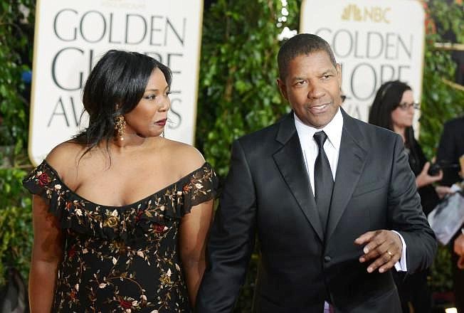 In a Sunday Jan. 13, 2013 file photo, actor Denzel Washington, right, and his daughter Olivia Washington arrive at the 70th Annual Golden Globe Awards at the Beverly Hilton Hotel, in Beverly Hills, Calif. Olivia Washington, one of Denzel Washington’s four children, has spent the spring of 2015 playing the shy and damaged Laura in a revival of Tennessee Williams’ “The Glass Menagerie” in a 199-seat theater in New York. Unlike so many other aspiring actresses, she’s not relying on her famous dad.