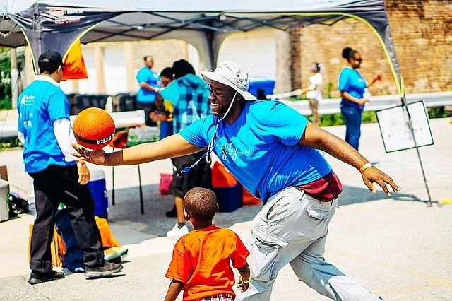 Volunteers play with children during a Claretian Associates PlayStreets event last year.