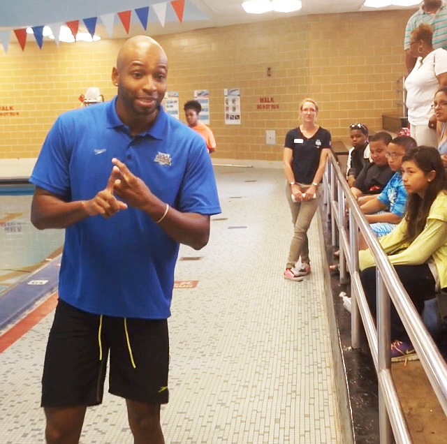 Two-time Olympic swimming gold medalist Cullen Jones speaks to children before taking them out in the pool for a swimming lesson at Foster Park, 1440 W. 84th St., as part of USA Swimming Foundation and Philips 66's "Make A Splash" initiative  aimed at teaching youth swimming basics to decrease drowning rates nationwide. 