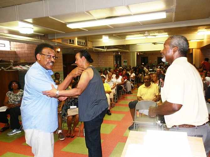 Dedra Delaney (center) steps in to calm tensions between an unidentified  impassioned resident (left) and Jerry Brown (right), an official with the Eight Ward Accountability Coalition, during a community meeting about a proposed opening of a medical marijuana dispensary slated to open in Chicago’s Chatham neighborhood.