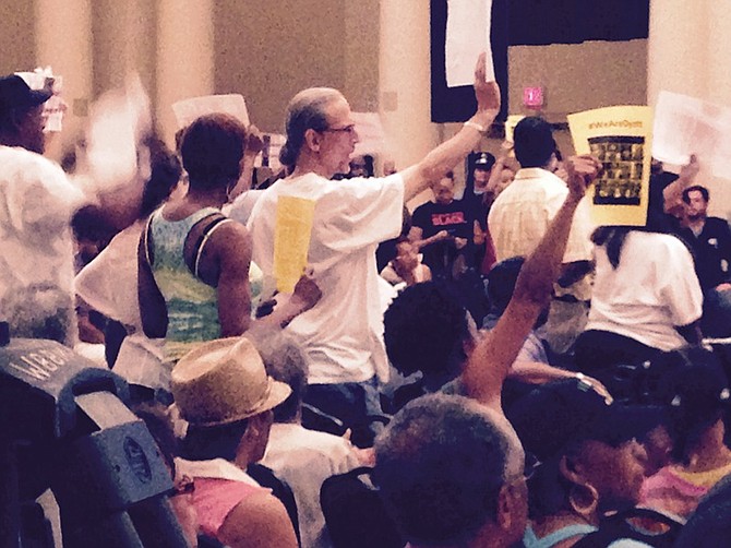 Protesters surround Chicago Mayor Rahm Emanuel at a budget town hall meeting last week.